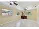 Large living room with tile flooring, natural light, and ceiling fans at 1810 77Th N Ave, St Petersburg, FL 33702