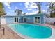 Private backyard pool with patio area, white privacy fence, and lush landscaping providing a serene outdoor space at 1818 Indian Rocks Rd S, Largo, FL 33774