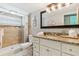 Bathroom boasting a granite vanity, modern lighting, and a tiled walk-in shower at 1818 Indian Rocks Rd S, Largo, FL 33774