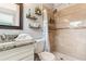 Bathroom featuring granite vanity, updated fixtures, and tile shower with patterned shower curtain at 1818 Indian Rocks Rd S, Largo, FL 33774