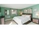 Bright bedroom with green walls, lots of natural light and neutral decor throughout at 1818 Indian Rocks Rd S, Largo, FL 33774