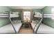 Bedroom featuring gray bunk beds, white bedding, and natural lighting at 1818 Indian Rocks Rd S, Largo, FL 33774