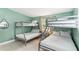 Bedroom featuring gray bunk beds, white bedding, and natural lighting at 1818 Indian Rocks Rd S, Largo, FL 33774