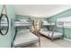 Bedroom featuring gray bunk beds, white bedding, and natural lighting at 1818 Indian Rocks Rd S, Largo, FL 33774