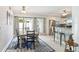 Dining area features a dining table with seating, access to the backyard, and a bar for easy indoor/outdoor living at 1818 Indian Rocks Rd S, Largo, FL 33774