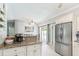 Open kitchen boasts granite countertops, stainless steel appliances, and a breakfast bar for modern convenience and entertaining at 1818 Indian Rocks Rd S, Largo, FL 33774
