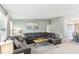 Spacious living room with modern furnishings, light wood floors, and a brick accent wall adds to the home's appeal at 1818 Indian Rocks Rd S, Largo, FL 33774