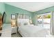Main bedroom features a sliding glass door that leads to a pool view at 1818 Indian Rocks Rd S, Largo, FL 33774