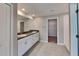 Bathroom featuring double sinks, granite counters, tile floors, and access to the walk-in closet at 1881 Colding Dr, Ruskin, FL 33570