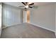 Standard bedroom with plush carpet, ceiling fan, and double door closet at 1881 Colding Dr, Ruskin, FL 33570
