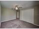 Bedroom featuring a ceiling fan, carpet, and a double-door closet at 1881 Colding Dr, Ruskin, FL 33570