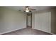 Cozy bedroom with carpeted floors, neutral walls, ceiling fan, and closet at 1881 Colding Dr, Ruskin, FL 33570