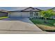 Charming home featuring a 2-car garage, well-maintained landscaping, and a welcoming entrance at 1881 Colding Dr, Ruskin, FL 33570