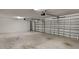 Spacious two car garage with concrete floor and overhead lighting at 1881 Colding Dr, Ruskin, FL 33570