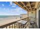 Outdoor seating on a private balcony offering unobstructed beach and gulf views at 19010 Gulf Blvd # 203, Indian Shores, FL 33785