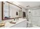 Bathroom showcasing vanity, mirror, and glass-enclosed shower at 19010 Gulf Blvd # 203, Indian Shores, FL 33785