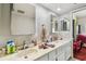 Bright bathroom featuring a double sink vanity with marble counters and large mirrors and views of the bedroom at 19010 Gulf Blvd # 203, Indian Shores, FL 33785