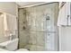 Modern bathroom with a marble-tiled shower, glass doors, and stylish fixtures at 19010 Gulf Blvd # 203, Indian Shores, FL 33785
