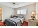 Inviting bedroom with ceiling fan, closet, and a large window at 19010 Gulf Blvd # 203, Indian Shores, FL 33785