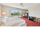 Bright bedroom with a ceiling fan and sliding glass doors leading to a balcony at 19010 Gulf Blvd # 203, Indian Shores, FL 33785