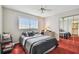 Comfortable bedroom featuring a ceiling fan, natural light, and closet at 19010 Gulf Blvd # 203, Indian Shores, FL 33785