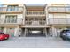 Three-story building with covered parking and beach access gate at 19010 Gulf Blvd # 203, Indian Shores, FL 33785