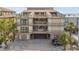 Multi-story condo building with private balconies offering outdoor living space and partial ocean views at 19010 Gulf Blvd # 203, Indian Shores, FL 33785