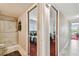Hallway view to bedroom and bath featuring marble tile flooring at 19010 Gulf Blvd # 203, Indian Shores, FL 33785