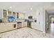 Bright kitchen with marble floors, stainless steel appliances, and modern lighting at 19010 Gulf Blvd # 203, Indian Shores, FL 33785