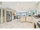 Modern kitchen with white cabinets, island seating and stainless-steel refrigerator at 19010 Gulf Blvd # 203, Indian Shores, FL 33785