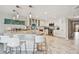 Bright kitchen with stainless steel appliances, island with bar seating, and white marble countertops at 19010 Gulf Blvd # 203, Indian Shores, FL 33785