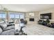 Living room with marble floors, slider to deck with ocean view and brick fireplace at 19010 Gulf Blvd # 203, Indian Shores, FL 33785