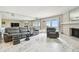 Living room with sliding doors to deck, ocean view, brick fireplace, marble floors and bar at 19010 Gulf Blvd # 203, Indian Shores, FL 33785