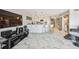 Open floorplan with updated kitchen, marble floors, and large entertainment center at 19010 Gulf Blvd # 203, Indian Shores, FL 33785