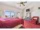Spacious primary bedroom with vaulted ceiling, water views, and comfortable seating area at 19010 Gulf Blvd # 203, Indian Shores, FL 33785