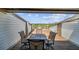 Outdoor deck featuring a table and chairs for enjoying the view of the surrounding neighborhood and nature at 19010 Gulf Blvd # 203, Indian Shores, FL 33785