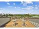 Outdoor deck area with two chairs offering views of nearby buildings and the natural landscape at 19010 Gulf Blvd # 203, Indian Shores, FL 33785