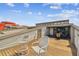 Elevated outdoor deck space with chairs, storage, and slider access to interior living space at 19010 Gulf Blvd # 203, Indian Shores, FL 33785