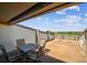 Outdoor deck featuring a table and chairs and other seating, for enjoying the view of the surrounding neighborhood at 19010 Gulf Blvd # 203, Indian Shores, FL 33785