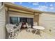 Inviting patio with stylish white furniture, offering a glimpse of the cozy bedroom and ocean view at 19010 Gulf Blvd # 203, Indian Shores, FL 33785