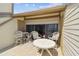 Comfortable patio area features a round table and chairs, perfect for relaxing and enjoying the outdoor ambiance at 19010 Gulf Blvd # 203, Indian Shores, FL 33785