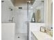 Modern walk-in shower featuring white marble tiling, a rainfall showerhead, and a glass enclosure at 19010 Gulf Blvd # 203, Indian Shores, FL 33785