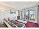 Relaxing sunroom with comfortable lounge seating and sliding glass doors to a deck with seating for outdoor enjoyment at 19010 Gulf Blvd # 203, Indian Shores, FL 33785