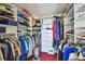 Organized walk-in closet with shelving, hanging rods, and a five-drawer cabinet for optimal storage solutions at 19010 Gulf Blvd # 203, Indian Shores, FL 33785