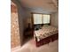 Comfortable bedroom includes a cozy bed, side table with a lamp, and a window with privacy blinds at 213 Mahogany Dr, Seffner, FL 33584