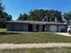 Charming one-story home featuring an attached two-car garage and mature landscaping on a sunny day at 213 Mahogany Dr, Seffner, FL 33584