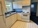 Bright kitchen featuring white appliances, cabinets and classic checkerboard-style flooring at 213 Mahogany Dr, Seffner, FL 33584