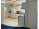 Kitchen featuring white appliances, cabinets, and flooring at 213 Mahogany Dr, Seffner, FL 33584