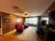 Inviting living room features wood paneled walls, comfortable seating, and natural light from a large window at 213 Mahogany Dr, Seffner, FL 33584