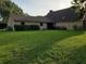 Expansive backyard featuring lush green grass and mature trees, perfect for outdoor activities and relaxation at 2615 Southern Oaks Pl, Plant City, FL 33566